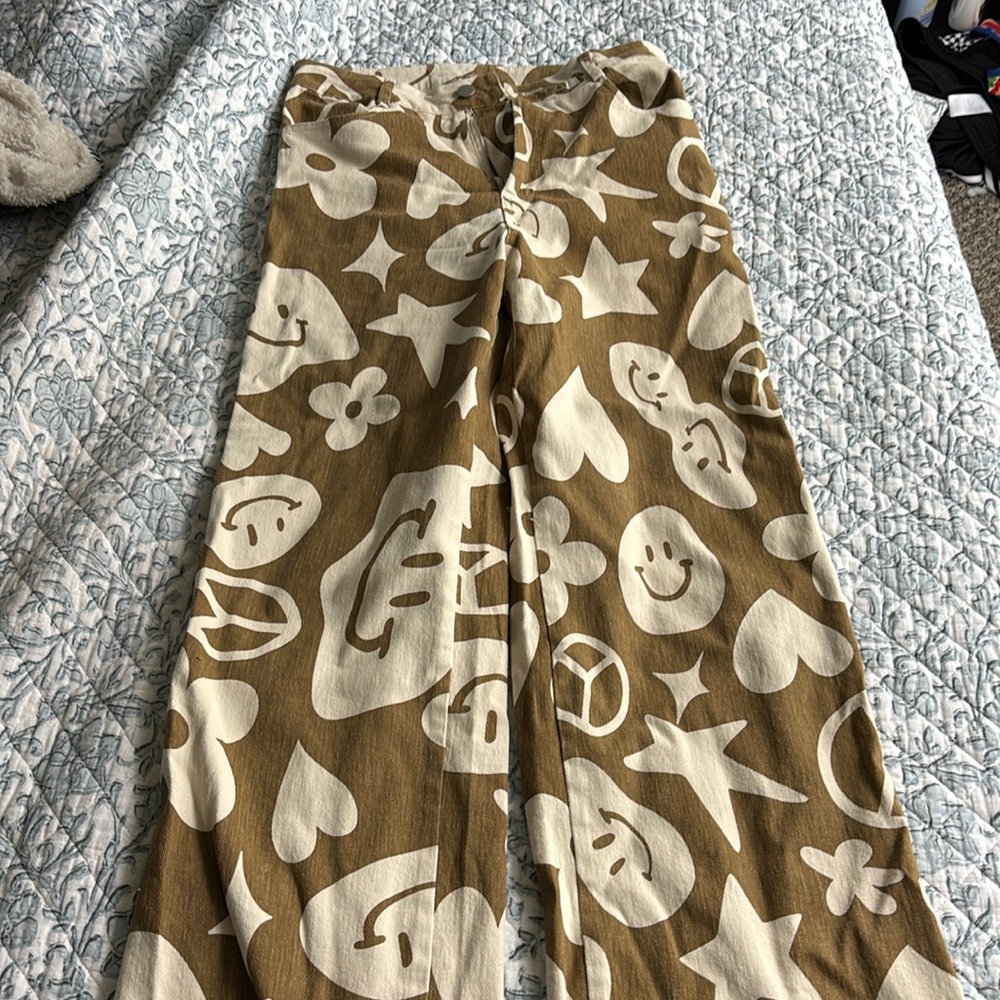 Boutique bought. Smiley face, peace sign, heart pants.